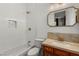 Bright bathroom featuring a shower-tub combo, neutral tiling, and modern hardware at 1200 Dry Point Ct, Las Vegas, NV 89144