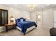 Spacious bedroom showcasing a blue velvet bedspread, matching side tables, and a modern light fixture at 1200 Dry Point Ct, Las Vegas, NV 89144