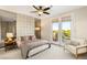 Bright bedroom featuring a comfortable bed with a padded headboard and double doors leading to a balcony at 1200 Dry Point Ct, Las Vegas, NV 89144
