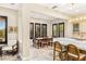 Open concept dining room featuring travertine floors, an elegant light fixture and seating for six at 1200 Dry Point Ct, Las Vegas, NV 89144
