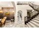 Grand foyer with decorative staircase, travertine flooring, and elegant lighting at 1200 Dry Point Ct, Las Vegas, NV 89144