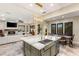 Open kitchen with island seating, seamlessly flowing into the living and dining spaces at 1200 Dry Point Ct, Las Vegas, NV 89144
