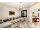 Comfortable living room featuring a sectional sofa, stylish lighting, and travertine floors at 1200 Dry Point Ct, Las Vegas, NV 89144