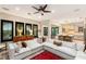 Bright living room with a large sectional sofa, dark shutters, and a ceiling fan at 1200 Dry Point Ct, Las Vegas, NV 89144