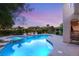 Sparkling pool with attached jacuzzi, surrounded by beautiful landscaping and an iron fence at 1200 Dry Point Ct, Las Vegas, NV 89144