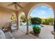 Covered outdoor seating area overlooking a beautiful pool and lush landscaping at 1200 Dry Point Ct, Las Vegas, NV 89144