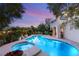 Sparkling pool with integrated spa, lush landscaping, and a serene backyard setting at 1200 Dry Point Ct, Las Vegas, NV 89144