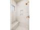 Marble shower with a shower bench, rain head shower head, and built in shelves at 1200 Dry Point Ct, Las Vegas, NV 89144