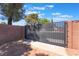 Enclosed backyard featuring a gate and brick perimeter, creating a private outdoor space at 1534 Irene Dr, Boulder City, NV 89005