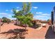 Large backyard with an outdoor seating area, recreational parking, and mature tree at 1534 Irene Dr, Boulder City, NV 89005