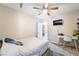 Bright bedroom featuring neutral walls, ceiling fan, desk, and carpeted flooring at 1534 Irene Dr, Boulder City, NV 89005