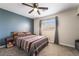 Cozy bedroom featuring a ceiling fan, natural light, and carpeted floors at 1534 Irene Dr, Boulder City, NV 89005