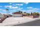 Charming single-story home with a well-maintained lawn, and palm trees, perfect curb appeal at 1534 Irene Dr, Boulder City, NV 89005