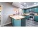 Updated kitchen features a stainless steel oven and microwave, breakfast bar, and sleek countertops at 1534 Irene Dr, Boulder City, NV 89005