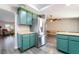 View of kitchen featuring modern stainless steel refrigerator and matching green cabinetry at 1534 Irene Dr, Boulder City, NV 89005