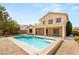 A backyard pool with a hot tub and a two-story home in the background at 17 Morninglow Pass, Henderson, NV 89052