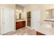 Bathroom featuring dual sinks, granite countertops, and walk-in shower at 17 Morninglow Pass, Henderson, NV 89052