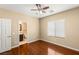 Bright bedroom features hardwood floors, ceiling fan, and ensuite bathroom at 17 Morninglow Pass, Henderson, NV 89052
