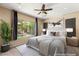 Serene primary bedroom suite with a large window, neutral color palette, and elegant furnishings at 17 Morninglow Pass, Henderson, NV 89052