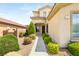 Close up of a home's exterior with a well-manicured front garden, sidewalk, and inviting entryway at 17 Morninglow Pass, Henderson, NV 89052