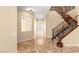 Inviting foyer showcasing a staircase with decorative railings, tiled floors, and views into adjoining rooms at 17 Morninglow Pass, Henderson, NV 89052