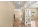 Spacious hallway featuring marble flooring and a view through french doors at 17 Morninglow Pass, Henderson, NV 89052