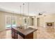 An open kitchen area with an island and stainless steel appliances at 17 Morninglow Pass, Henderson, NV 89052