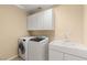 Laundry room featuring a washer, dryer, cabinets, and a sink at 17 Morninglow Pass, Henderson, NV 89052
