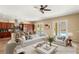 Open-concept living area showcasing a stylish seating arrangement, adjacent to a well-appointed kitchen with a breakfast bar at 17 Morninglow Pass, Henderson, NV 89052