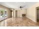 Spacious living room featuring travertine flooring, fireplace, and glass doors leading to the pool at 17 Morninglow Pass, Henderson, NV 89052