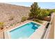 Beautiful backyard with a sparkling pool, desert landscaping and scenic views at 17 Morninglow Pass, Henderson, NV 89052