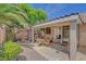 Charming backyard patio with pergola, outdoor seating, and well-manicured landscaping, perfect for entertaining at 1931 Jasper Creek Pl, Las Vegas, NV 89123