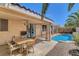 Inviting backyard patio featuring outdoor dining space, lush landscaping, and access to a refreshing pool at 1931 Jasper Creek Pl, Las Vegas, NV 89123