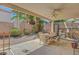 Backyard patio with dining set and manicured landscaping at 1931 Jasper Creek Pl, Las Vegas, NV 89123