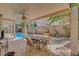 Backyard patio with covered dining area, overhead fan, and serene views of the landscaped yard and pool at 1931 Jasper Creek Pl, Las Vegas, NV 89123