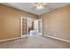 Neutral bedroom featuring carpet flooring, ceiling fan, and an entry way to the rest of the house at 1931 Jasper Creek Pl, Las Vegas, NV 89123