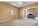 Neutral bedroom featuring carpet flooring and an entry way into the living room at 1931 Jasper Creek Pl, Las Vegas, NV 89123