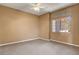 Neutral bedroom featuring carpet flooring, ceiling fan and natural light from the windows at 1931 Jasper Creek Pl, Las Vegas, NV 89123
