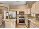 Bright kitchen features stainless steel appliances and granite countertops for a modern touch at 1931 Jasper Creek Pl, Las Vegas, NV 89123