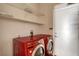 Functional laundry room equipped with modern washer/dryer and shelving, making laundry chores a breeze at 1931 Jasper Creek Pl, Las Vegas, NV 89123