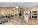 Open-concept living area featuring a fireplace, kitchen, and comfortable seating at 1931 Jasper Creek Pl, Las Vegas, NV 89123