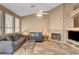 Inviting living room with fireplace, neutral tones, and lots of natural light at 1931 Jasper Creek Pl, Las Vegas, NV 89123