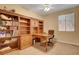 Dedicated office space featuring built-in shelving, desk, and abundant natural light, fostering productivity at 1931 Jasper Creek Pl, Las Vegas, NV 89123