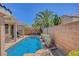 A luxurious backyard pool featuring a covered patio and lush landscaping for ultimate relaxation and enjoyment at 1931 Jasper Creek Pl, Las Vegas, NV 89123