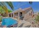 Backyard oasis with a refreshing pool, covered patio, and lush landscaping, perfect for outdoor enjoyment at 1931 Jasper Creek Pl, Las Vegas, NV 89123