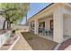 Charming backyard featuring a covered patio, garden, and ample space for entertaining or relaxation at 1945 Trail Peak Ln, Las Vegas, NV 89134