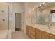 Bright bathroom with dual sinks, tile floor, and large glass-enclosed shower at 1945 Trail Peak Ln, Las Vegas, NV 89134