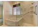 Clean bath with tub and shower combo, featuring a marble-look surround at 1945 Trail Peak Ln, Las Vegas, NV 89134