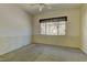 Neutral bedroom with ceiling fan, carpet, and a view to the front yard at 1945 Trail Peak Ln, Las Vegas, NV 89134
