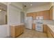 Functional kitchen featuring standard appliances, oak cabinets, and tile flooring at 1945 Trail Peak Ln, Las Vegas, NV 89134